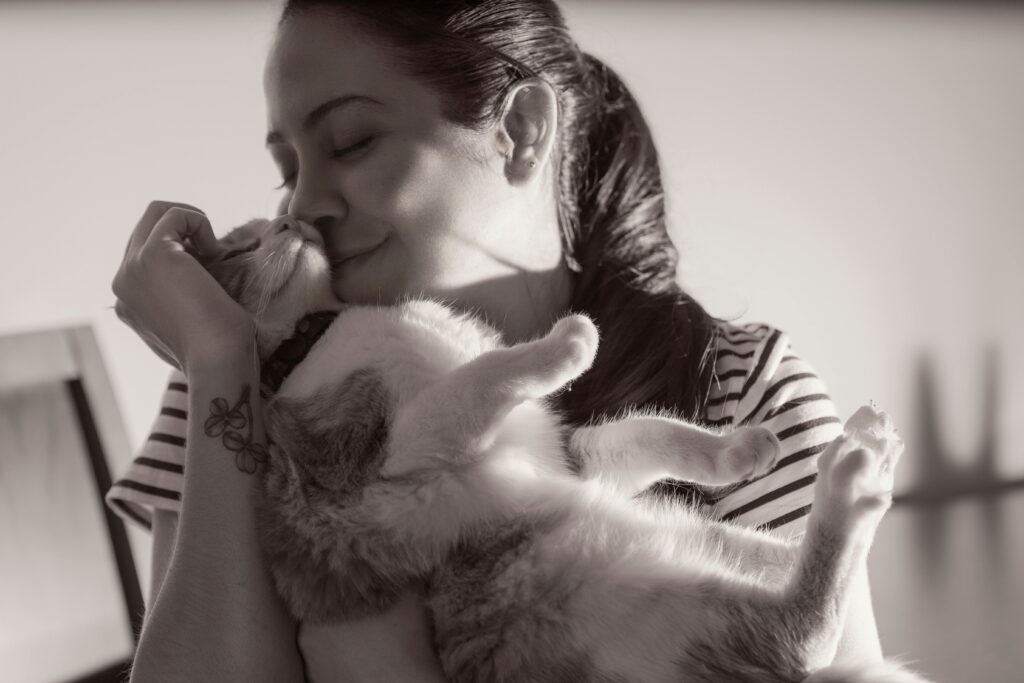 A tender moment captured between a woman and her cat in Heredia, Costa Rica.